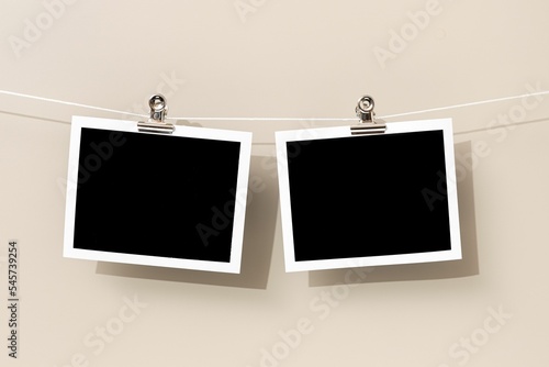 Two Blank Vintage instant photo frame hanging on a rope