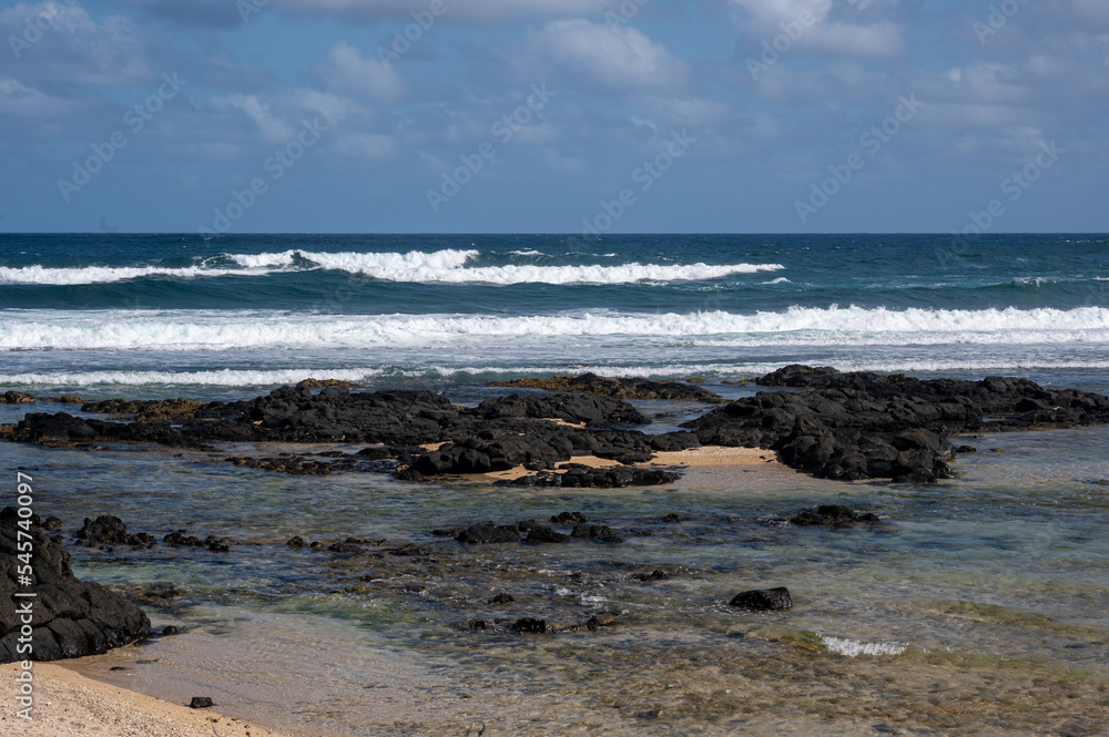 Waves breaking at the edge of the coral reef, Souillac Beach, Mauritius Waves breaking at the edge of the coral reef, Souillac Beach, Mauritius