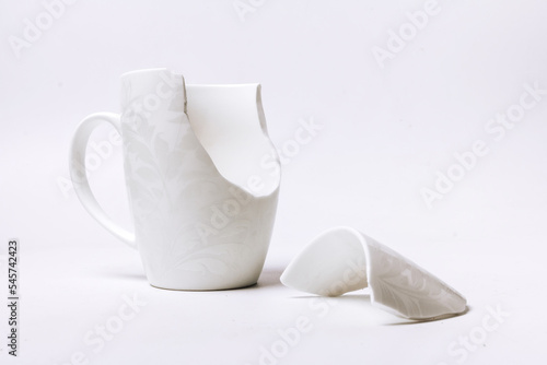 broken white cup with a pattern, on a white background