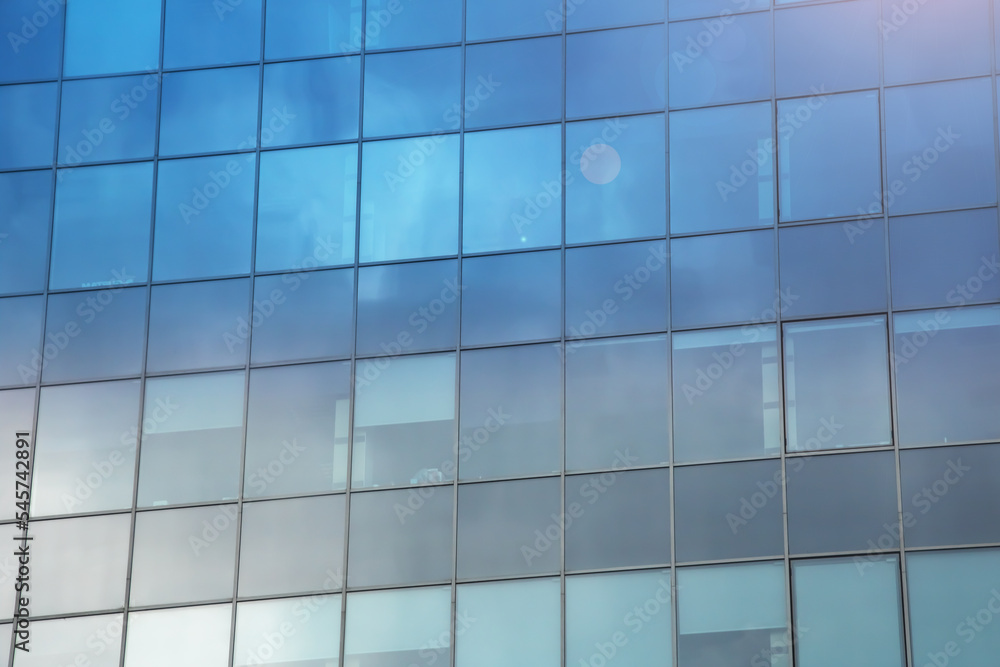 Reflection of clouds in mirrored windows of building Reflection of clouds in mirrored windows of building