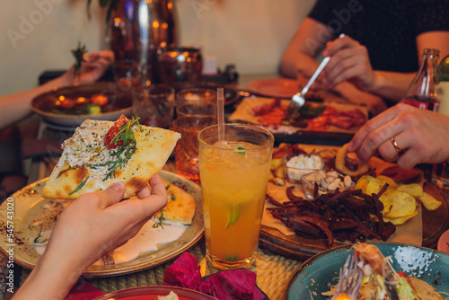 Clinking glasses with alcohol and toasting, party. photo