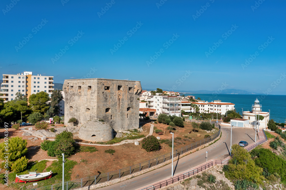 Coastal view of Oropesa del Mar, Spain, showing Torreon del Rey, guard tower, and lighthouse in the background,