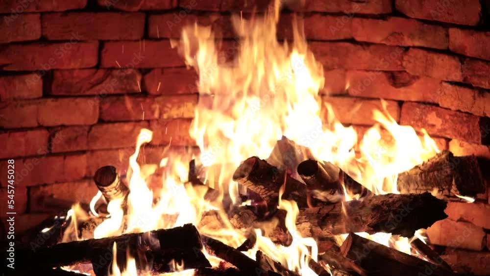 Firewood is burning in the fireplace Firewood is burning in the fireplace