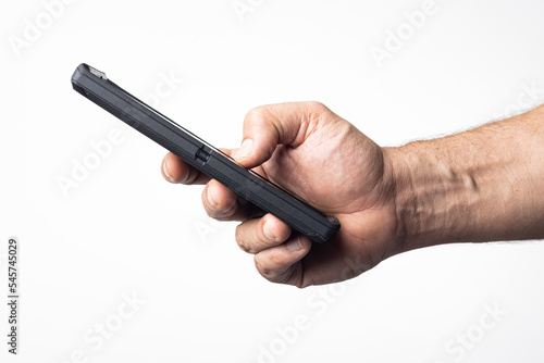 Hand and arm of a man holding a cell phone on a nuclear white background.