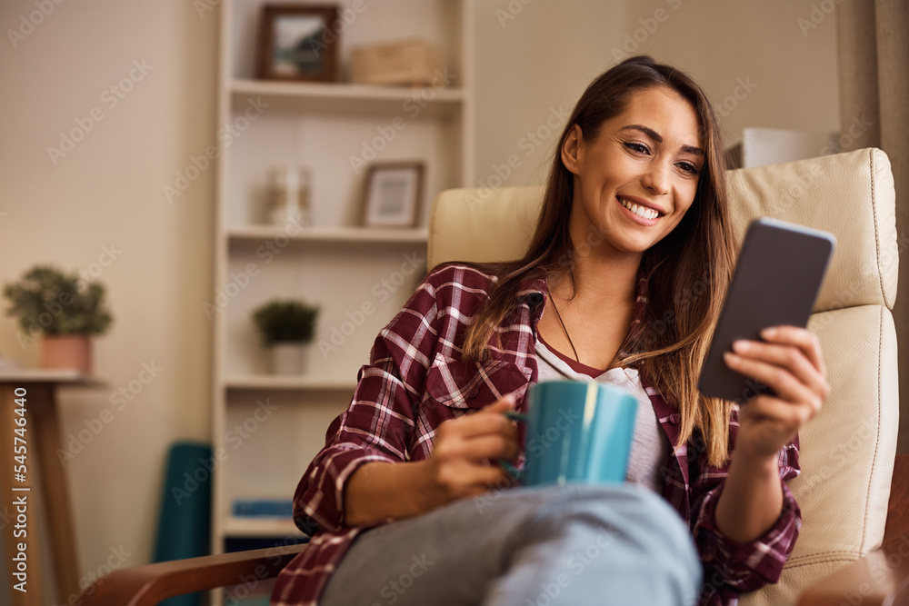 Happy woman texting on cell phone while having cup of coffee at home. Happy woman texting on cell phone while having cup of coffee at home.