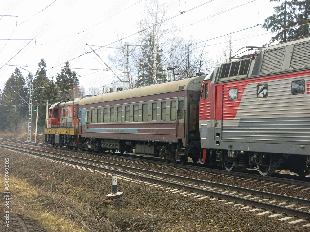 Fototapeta premium red technical train passes through the railway tracks in winter
