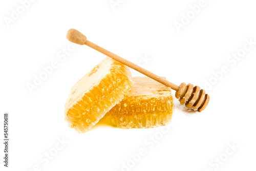 Honeycomb and wooden drizzler isolated on white background.