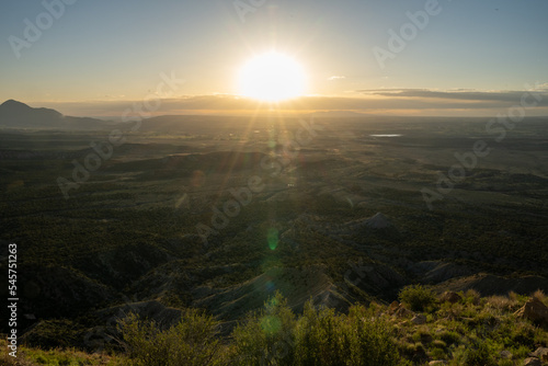 Sun Setting Over Valley Below Mesa Verde © kellyvandellen