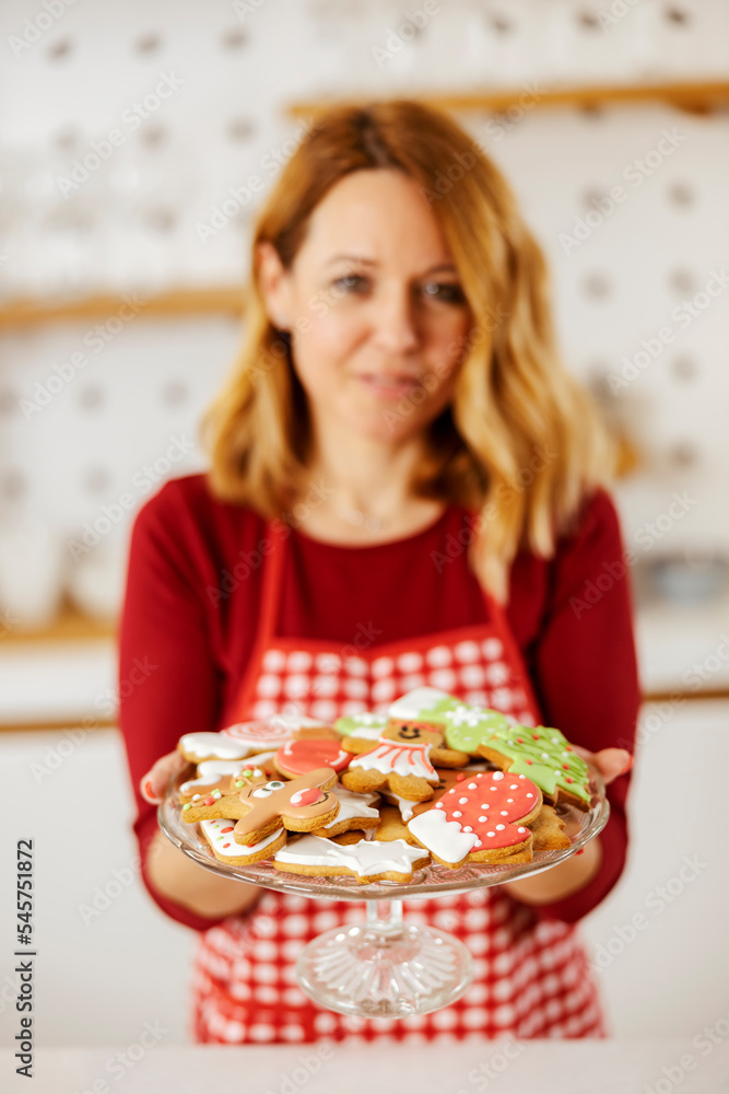 Selective focus on hands holding plate with fresh home made ginger cookies made for christmas eve. Selective focus on hands holding plate with fresh home made ginger cookies made for christmas eve.