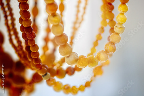 Various amber beads on a  bright background
