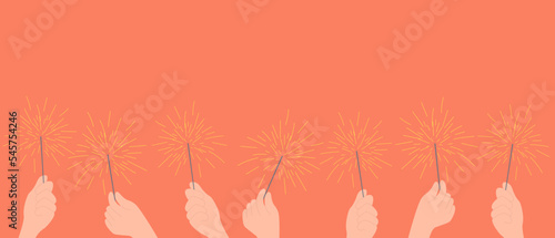 Festive Christmas sparklers decoration lighting element. Holiday background with more hands