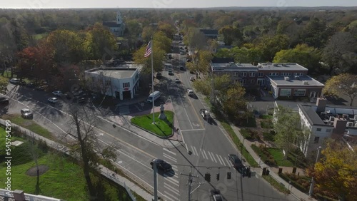 autumn flying past American flag flapping over Bridgehampton NY photo