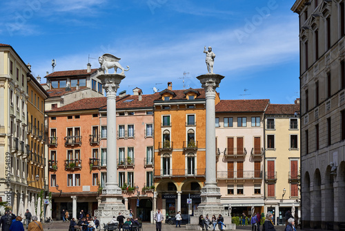  Tourists stroll in Piazza dei Signori in Vicenza, in the background two ancient columns, the Column of the Redeemer and the Column of the Lion photo