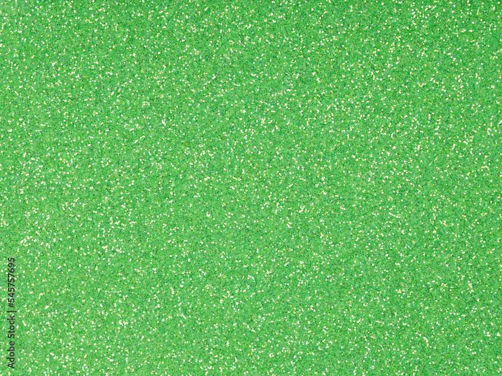 Fototapeta premium Festive soft green holographic glitter. Bright glowing green background for St.Patrick's Day, Christmas, New Year, xmas gift card or other holiday pictures. Beautiful packaging material.
