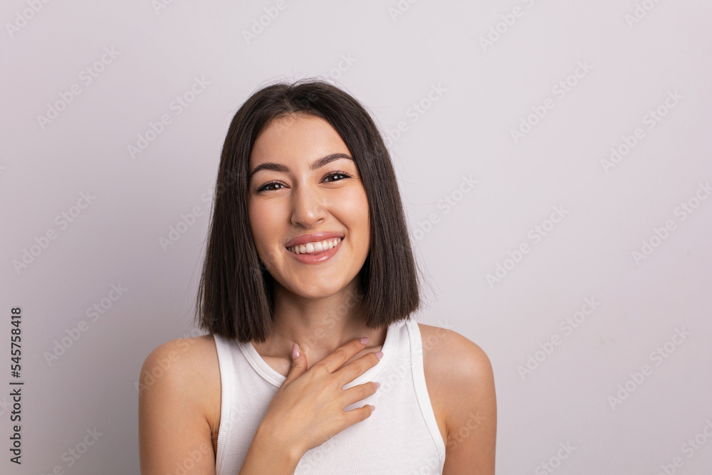 beauty portrait of a beautiful cheerful young oriental woman in a white T-shirt in the studio on a white wall. make-up artist and hairdresser hairdresser in a beauty salon. beauty portrait of a beautiful cheerful young oriental woman in a white T-shirt in the studio on a white wall. make-up artist and hairdresser hairdresser in a beauty salon.