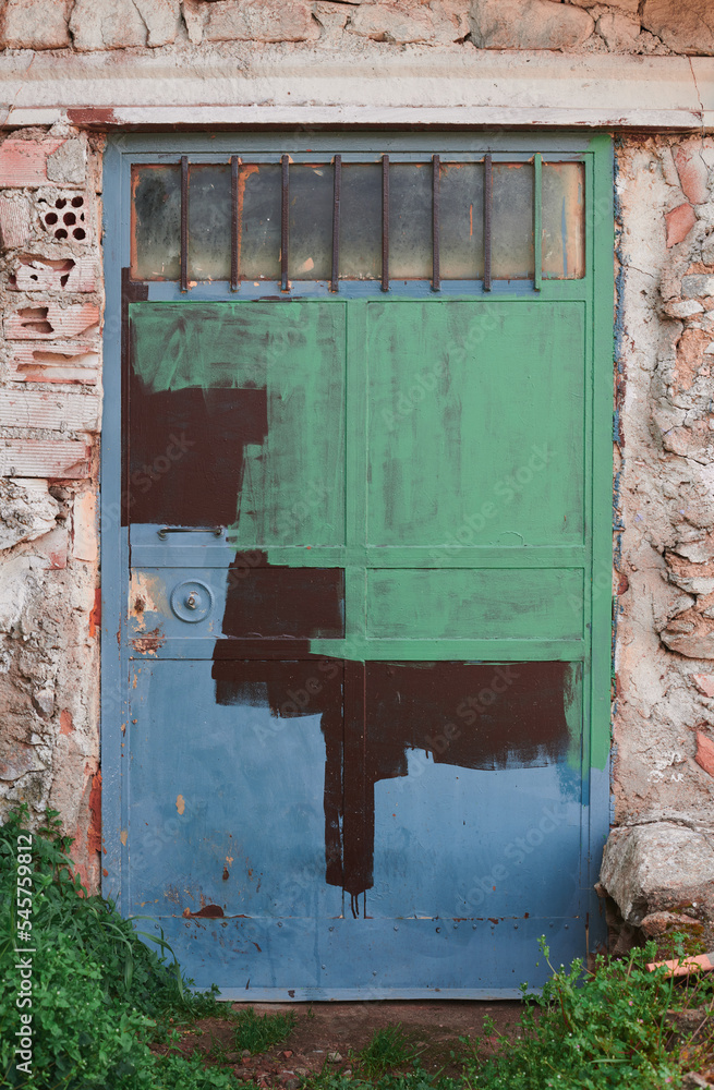 Old, picturesque main front door in mediterranean region house.