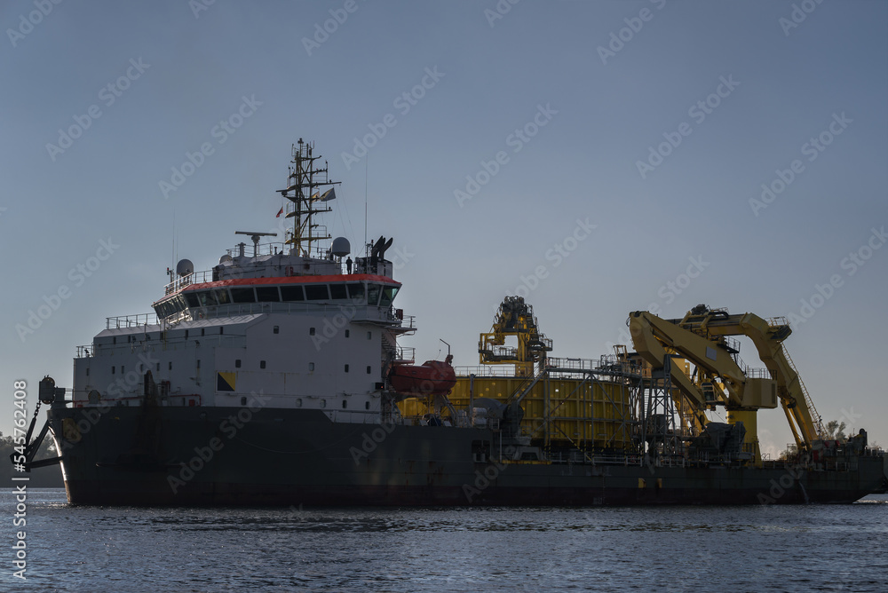 MARITIME ENGINEERING - Cable laying vessel is sailing along the port channel to sea