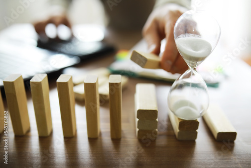 Closeup thick domino wood block in a row stop the falling, be stable in crisis, business solution concept