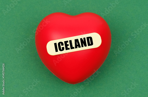 On a green surface lies a red heart with the inscription - Iceland