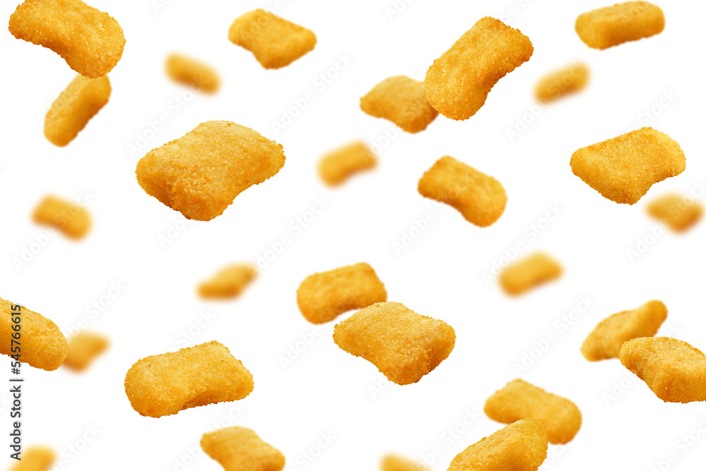 Falling Nuggets isolated on white background, selective focus Falling Nuggets isolated on white background, selective focus