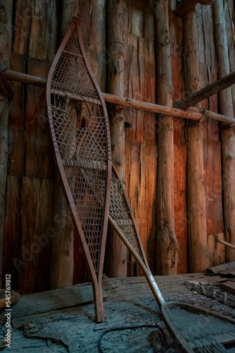 A pair of old Iroquois showshoes leans up against a wooden wall inside a longhouse at Crawford Lake near Milton, Ontario. photo