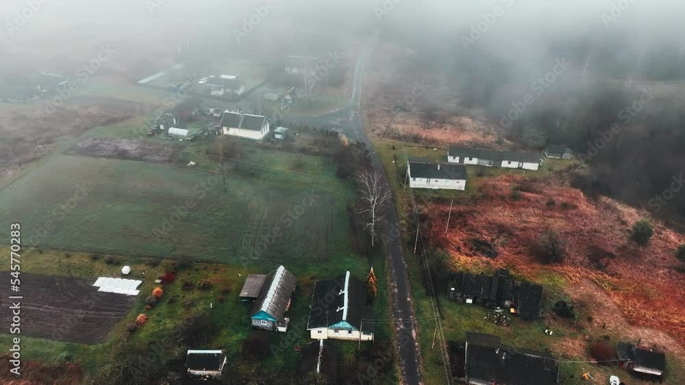 Village houses in fog, aerial view. Fog over mystical country. Morning mist haze in rural. Country house in Foggy autumn. Morning scene in misty village. Rural landscape in mist haze. Countryside . Village houses in fog, aerial view. Fog over mystical country. Morning mist haze in rural. Country house in Foggy autumn. Morning scene in misty village. Rural landscape in mist haze. Countryside .
