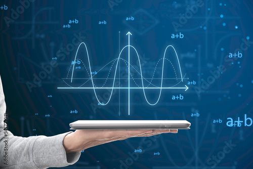 Close up of female hand holding cellphone with abstract glowing mathematical formula graph on blue background. Equation, digital data and mathematics app concept. photo