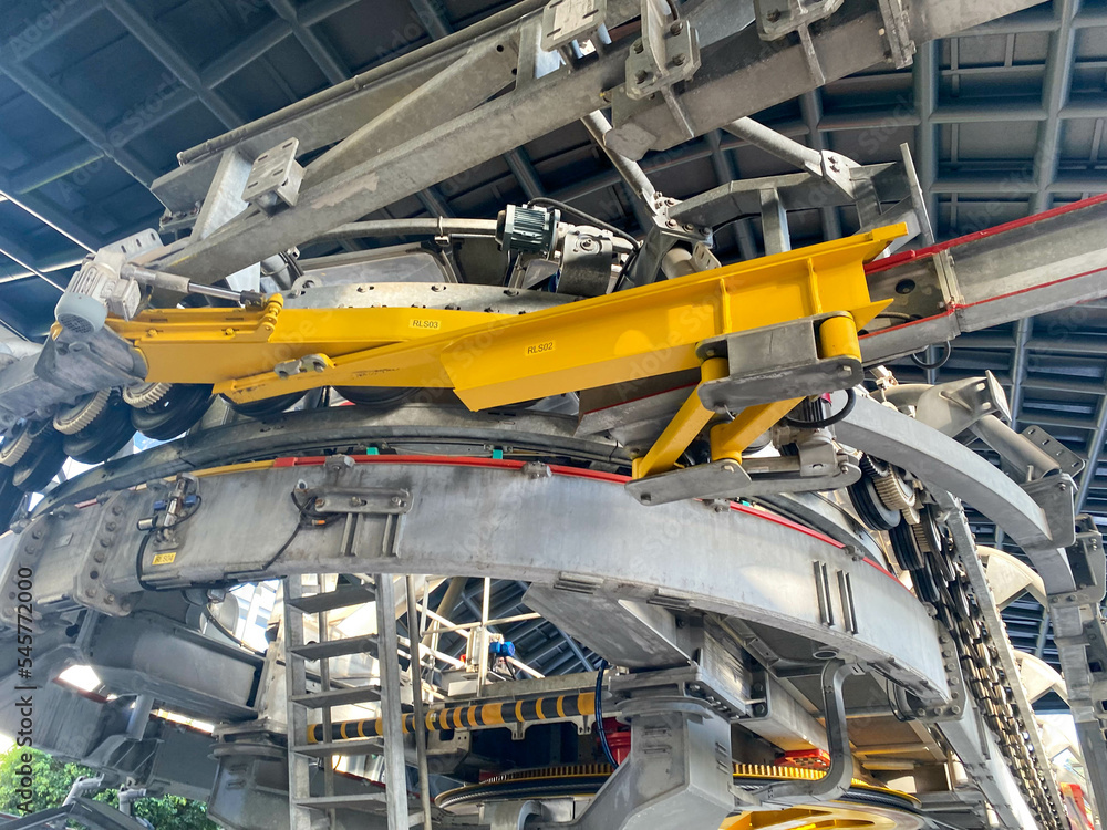 Fototapeta premium Metal industrial equipment, conveyor with chains and gears for moving cargo