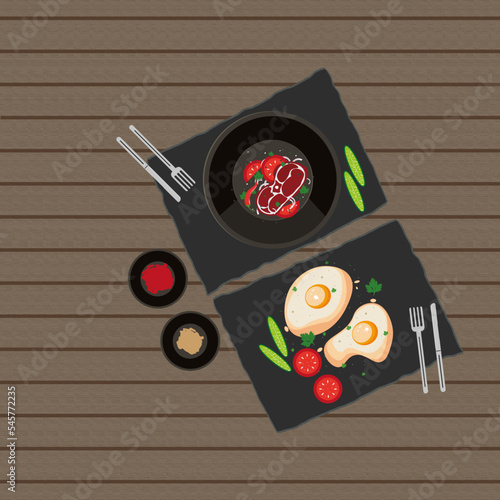 Dishes from the restaurant, fried steak with vegetables and fried eggs with aromatic herbs in stone black dishes