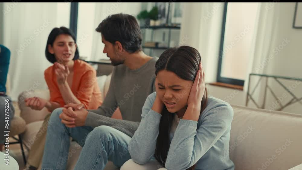 Psychological problem of parents. Parents swearing at a psychologist's appointment while the teenage daughter covers her ears with her hands. Family therapy. Psychological problem of parents. Parents swearing at a psychologist's appointment while the teenage daughter covers her ears with her hands. Family therapy.