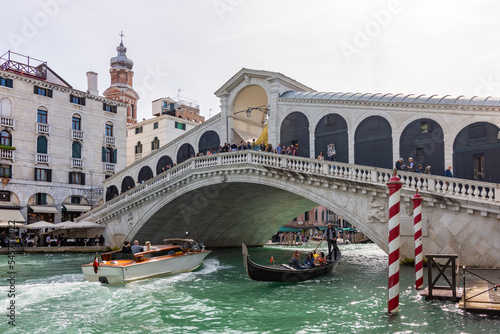 Gondolas and boats on Grand canal and Rialto bridge, Venice, Italy