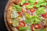 Pizza with chicken, vegetables, lettuce and bacon