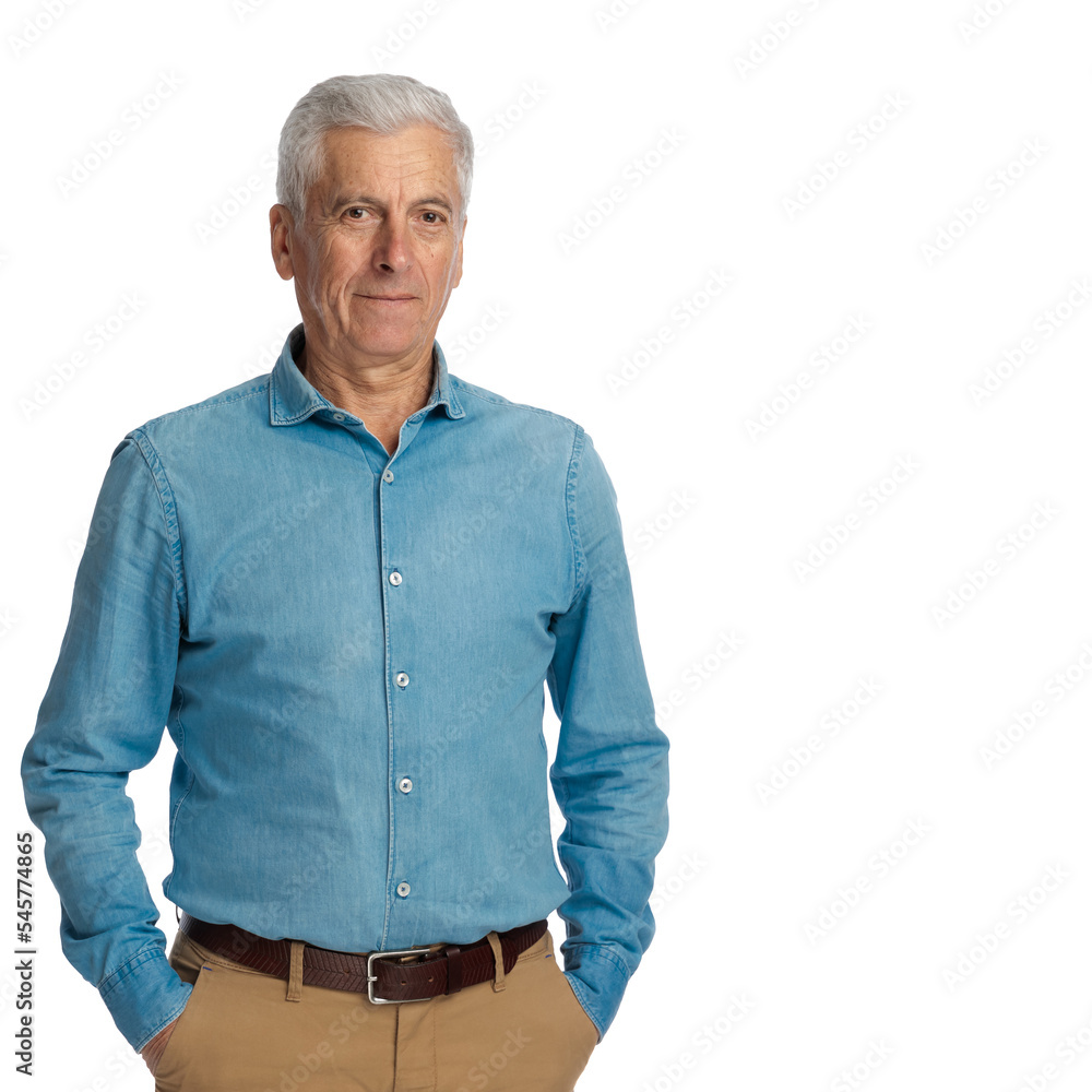 casual old man with grizzled hair posing with hands in pockets and smiling casual old man with grizzled hair posing with hands in pockets and smiling