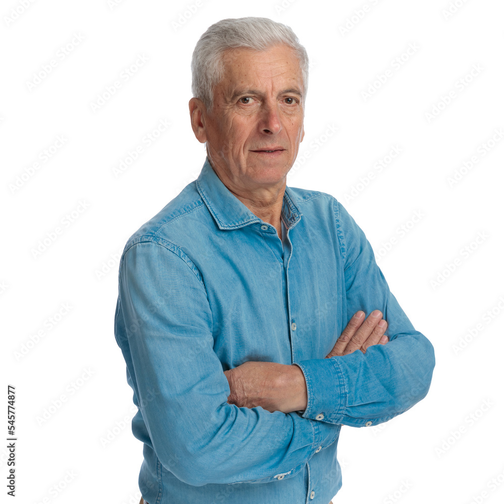 confident old man in denim shirt folding arms and posing confident old man in denim shirt folding arms and posing