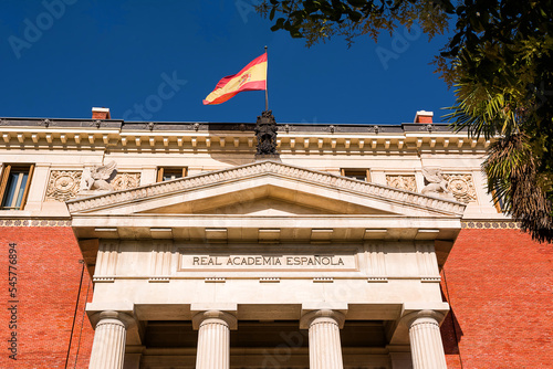 Detail of the tympanum on the building of the Real Spanish Academy (RAE) with flag on top photo