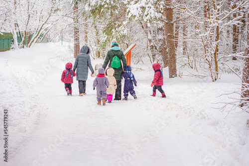 Children walk of children with teachers in nature on winter day
