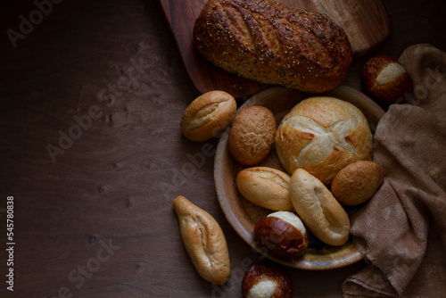 Mini Bread and Rolls on Wood Surface with Shadows