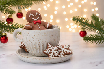 Gingerbread cookie man in a cup of hot chocolate or cappuccino