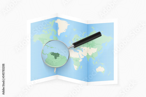 Enlarge Venezuela with a magnifying glass on a folded map of the world.