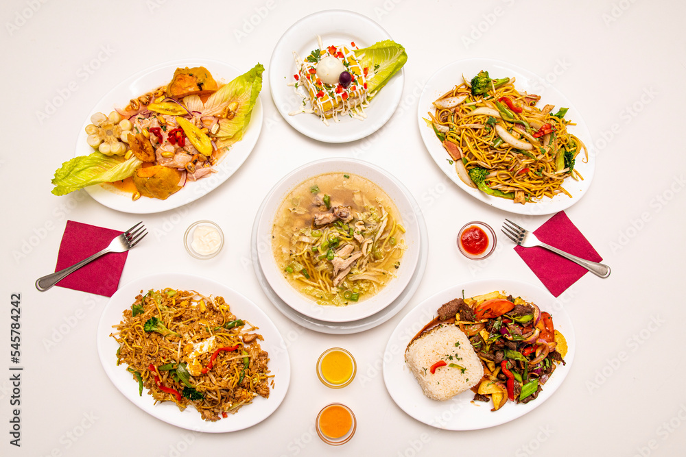 Selection of Peruvian food dishes with lomo saltado with rice, chicken