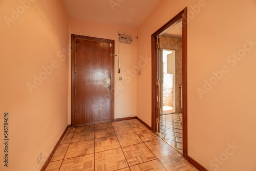 Hall of an empty house with walls painted peach color