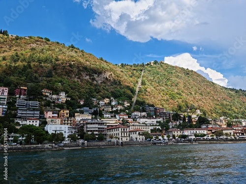 Lake Como country on a summer sunny day. View of the bay. Lake Como and mountains. Scenic view of the resort town. Beautiful Italian landscape.