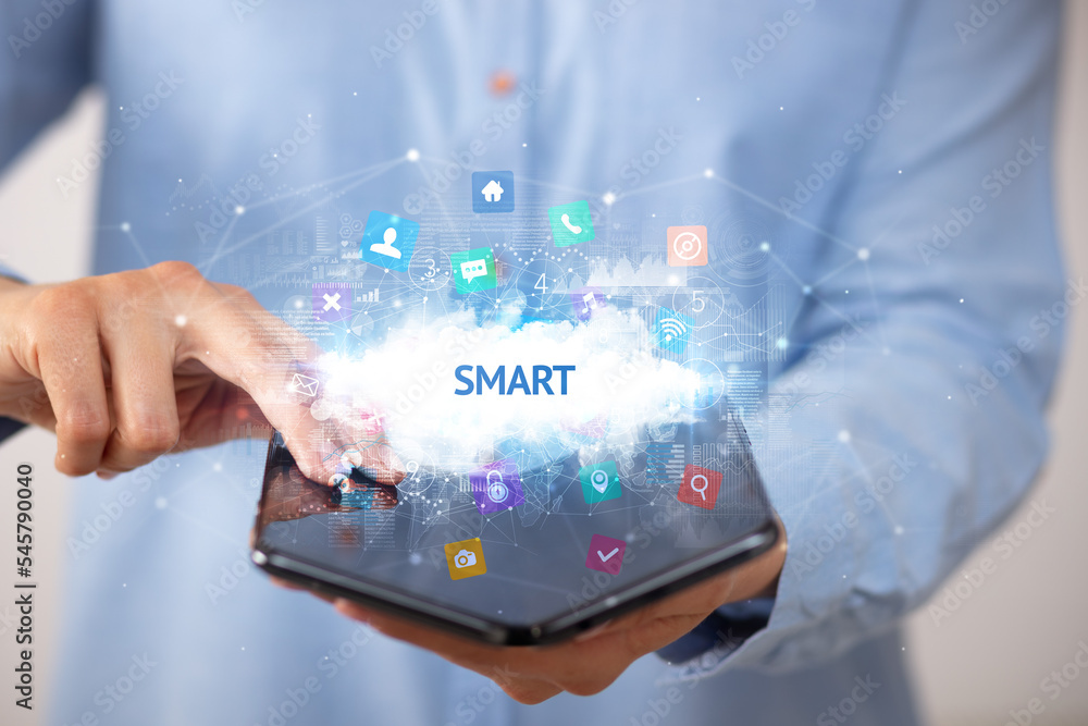 Businessman holding a foldable smartphone, technology concept Businessman holding a foldable smartphone, technology concept