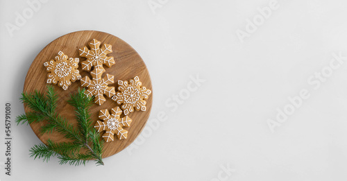 Christmas traditional gingerbread cookies decorated with sugar icing and a fir branch