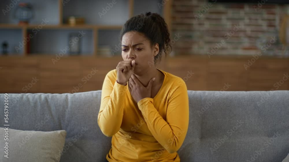 Young african american woman coughing hard at home, suffering from seasonal respiratory infection, free space Young african american woman coughing hard at home, suffering from seasonal respiratory infection, free space