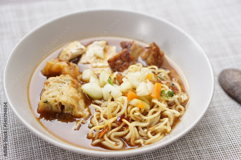 Tahu acar is traditional food from Solo, Middle Java Indonesia. Made from tofu pong and tempeh combined with pickled cucumber, wet yellow noodles, spicy sauce and other accompaniments.