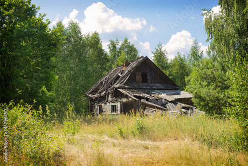 Landscape with an abandoned wooden house, desolation and ruin