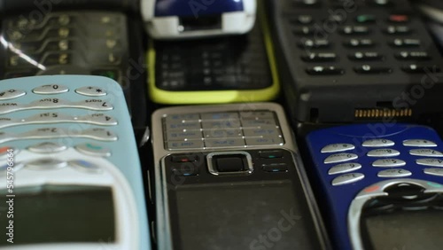 Heap of Used old mobile phone with keyboards. Many types and generations, Reuse and Recycling Electronic waste concept. photo