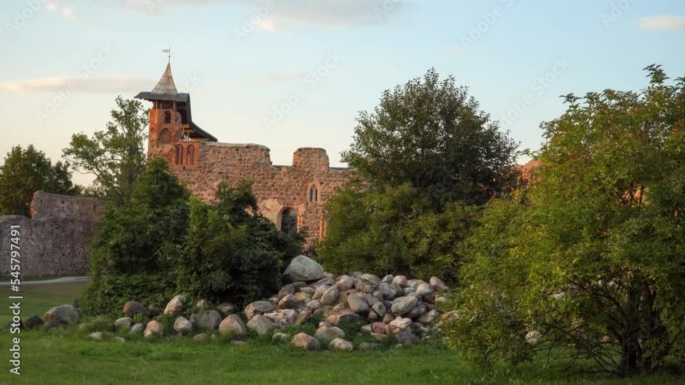 Dobele castle's central building was built from boulders with a tower in Latvia, Europe. The scenic view of this medieval architectural monument is in a zoom-in motion scene. Dobele castle's central building was built from boulders with a tower in Latvia, Europe. The scenic view of this medieval architectural monument is in a zoom-in motion scene.