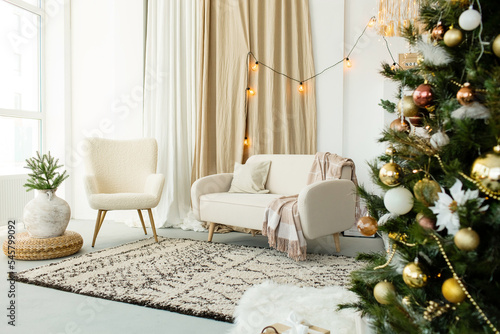 Modern interior design living room with Christmas decorations, toys, gifts, fir tree.